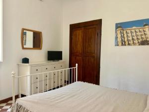 a bedroom with a bed and a wooden door at Matteotti 45 in Sarzana
