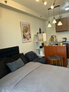 a bedroom with a bed and a table and a kitchen at Bellvoir Luxe 1 in Suba