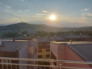 a view of a city with the sun in the background at WestHorizont in Sarajevo