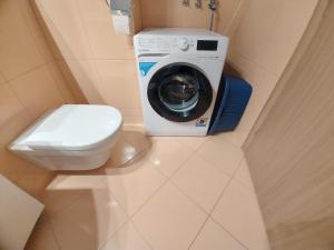 a bathroom with a toilet and a washing machine at WestHorizont in Sarajevo