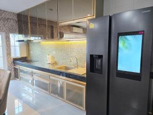 a kitchen with a refrigerator and a sink at Elegant 3 Bedrooms Home near MRT Central WestGate and Central WestVille 3 to 10 Min Drive  +34 photos