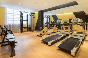 a gym with several treadmills and exercise equipment at Atour Hotel Guangzhou Huadu Square in Huadu