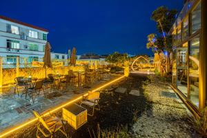 a restaurant with tables and chairs at night at Atour Hotel Guangzhou Huadu Square in Huadu