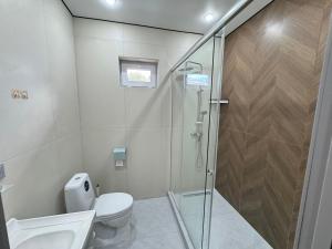 a bathroom with a shower and a toilet and a sink at Damir hotel in Aktobe