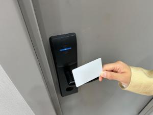 a person holding a piece of paper in a door handle at Damir hotel in Aktobe +14 photos