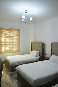 Postel nebo postele na pokoji v ubytování Royal Suite Hotel Apartments