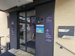 a building with a door with a sign on it at No1 - Flo's modern Rooms & Breakfast in Wagrain