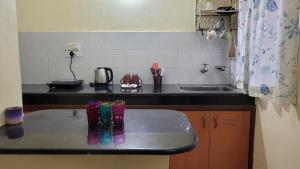 a kitchen with a counter with glasses on it at THE 101 HOMESTAY, Calangute by ROSH HOSPITALITY in Calangute