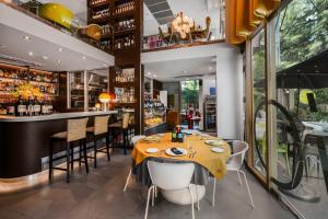 a restaurant with a table and chairs and a bar at Alcove 53 in Bangkok