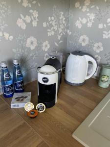 a counter top with a coffee maker and a toaster at Smuuli Päikesepesa in Kuressaare +6 photos