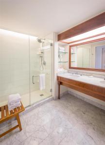a bathroom with a tub and a sink and a shower at Grand Hyatt Kauai Resort & Spa in Koloa