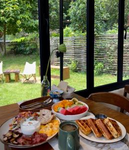 a table with two plates of food on it at Yangshuo Hillside Homestay in Yangshuo