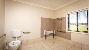 a bathroom with a toilet and a window at 'Mandalay Villa 2' in Paxton +5 photos
