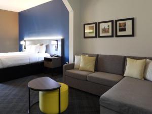 a hotel room with a couch and a bed at Comfort Suites in Crossville +49 photos