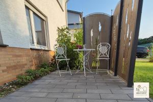 a table and two chairs on a patio at Einzigartige Ferienwohnung -hier im jetzt- in Felsberg