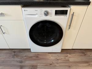 a white washing machine sitting in a kitchen at Deluxe Family Appartements Haem in Freiburg im Breisgau