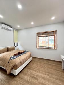 a bedroom with a bed and a window at Emmaree Villa in Ban Chong Phli +11 photos