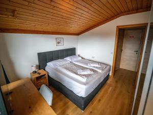 a bedroom with a bed and a wooden ceiling at Double room in Saalfelden by the Steinernes Meer in Saalfelden am Steinernen Meer