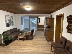 a living room with a couch and a table at Double room in Saalfelden by the Steinernes Meer in Saalfelden am Steinernen Meer