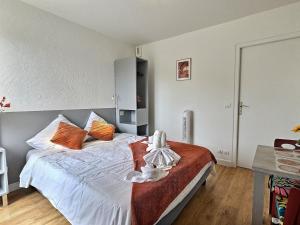 a bedroom with a bed with a doll on it at La Dolce Vita I Disney Paris Balcon in Chelles