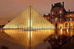 a large glass pyramid in front of a building at La Dolce Vita I Disney Paris Balcon in Chelles