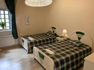 a room with two beds and a window at Casa Riviera in Zahlé