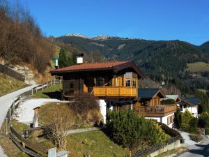 a house on a hill next to a road at Chalet on the slopes in Piesendorf