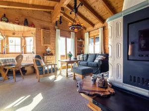 a living room with a couch and a table at Chalet on the slopes in Piesendorf