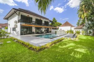 an exterior view of a house with a swimming pool at Eden Villa A Tropical Paradise Pool Villa in Rawai Beach