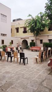 a group of chairs and tables in a courtyard at The Imperial Regency in Porbandar +75 photos