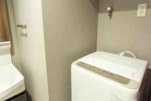 a washing machine in a bathroom with a sink at BON Condominium Namba Ebisu in Osaka +15 photos
