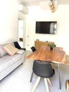 a living room with a wooden table and a couch at Luxi Apartment Teulada in Teulada