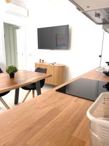 a dining room with a table and a tv at Luxi Apartment Teulada in Teulada +4 photos