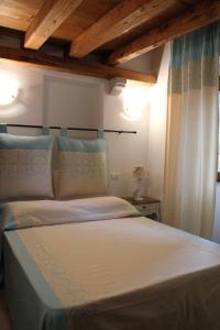 En eller flere senge i et værelse på B&B Piazza di L'Ara
