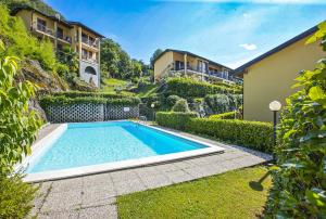 a swimming pool in the yard of a house at Residenz La Fonte Studios in Pino Lago Maggiore