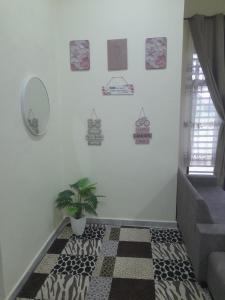 a hallway with a staircase with a potted plant at Marissa Homestay  +3 photos