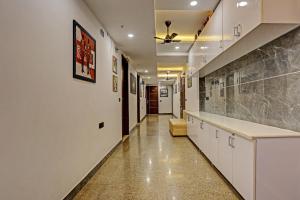 a long hallway with white cabinets and a long counter at Hotel O Golden Eye Inn in New Delhi +20 photos