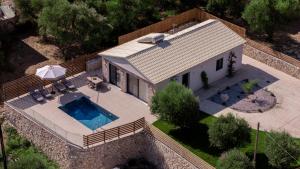 an overhead view of a house with a swimming pool at An ar Villa in Tragaki