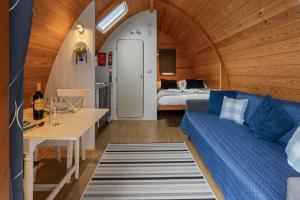 a room with a couch and a table and a bed at Lakeside Haven -Fishing Lakes, Heated Outdoor Swimming Pool 500yrds on Sister Park , Pool Open May to September in Cheriton Bishop