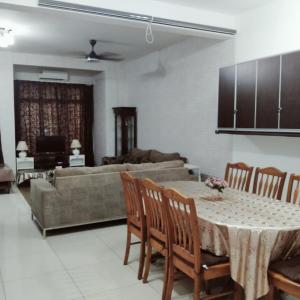 a living room with a table and a couch at 4-room double storey house, 10km KLIA in Sepang