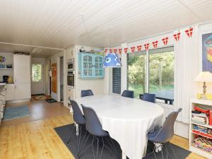 a kitchen and dining room with a table and chairs at Secluded Spa Retreat - By Traum Ferienwohnungen in Lønstrup