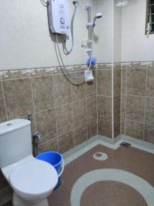 a bathroom with a shower with a toilet in it at 4-room double storey house, 10km KLIA in Sepang