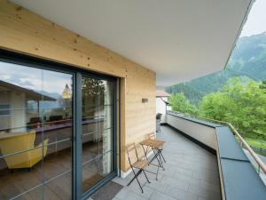 a balcony of a house with a view of the mountains at Chalet in Sankt Johann near Ski Slopes in Alpendorf