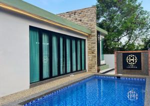 a house with a swimming pool next to a building at The Luxurious 23, GameTopia Villa in Johor Bahru