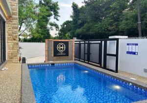 a swimming pool with a sign on the side of a house at The Luxurious 23, GameTopia Villa in Johor Bahru