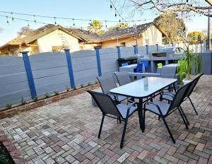 Una mesa y sillas en un patio de ladrillo. en LoopLê, en Klerksdorp