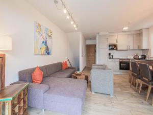 a living room with a couch and a kitchen at Chalet in Niedernsill near Ski Slopes in Niedernsill