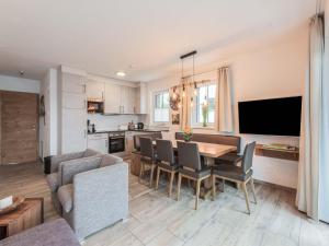 a kitchen and living room with a table and chairs at Chalet in Niedernsill near Ski Slopes in Niedernsill