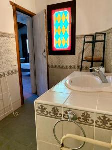 a bathroom with a sink and a stained glass window at Studio by the sea in Santa Ponsa
