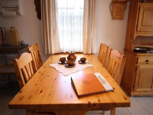 a wooden table in a kitchen with a book on it at Family Stay in Aletsch Alps in Bellwald